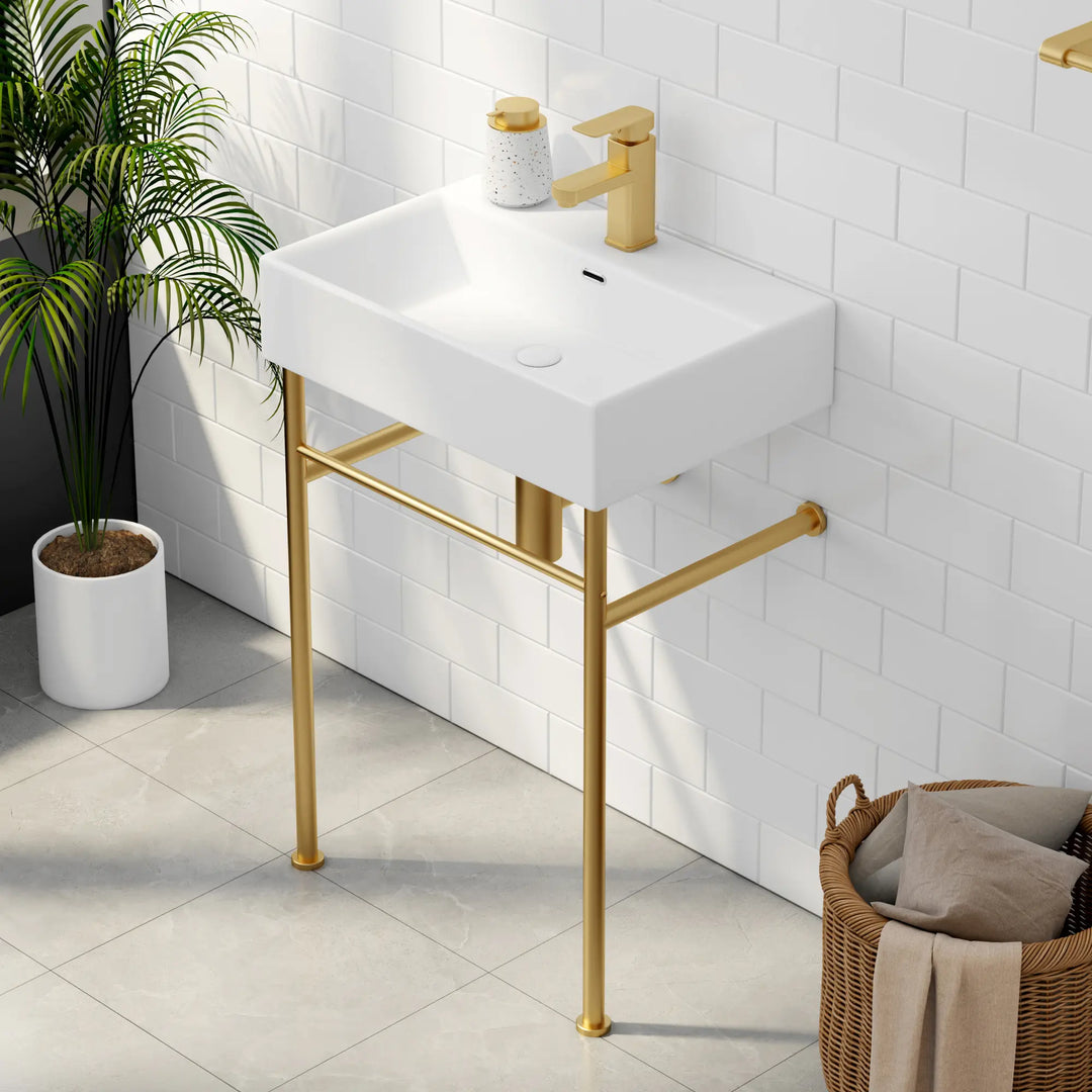 White rectangular sink with gold faucet and metal legs