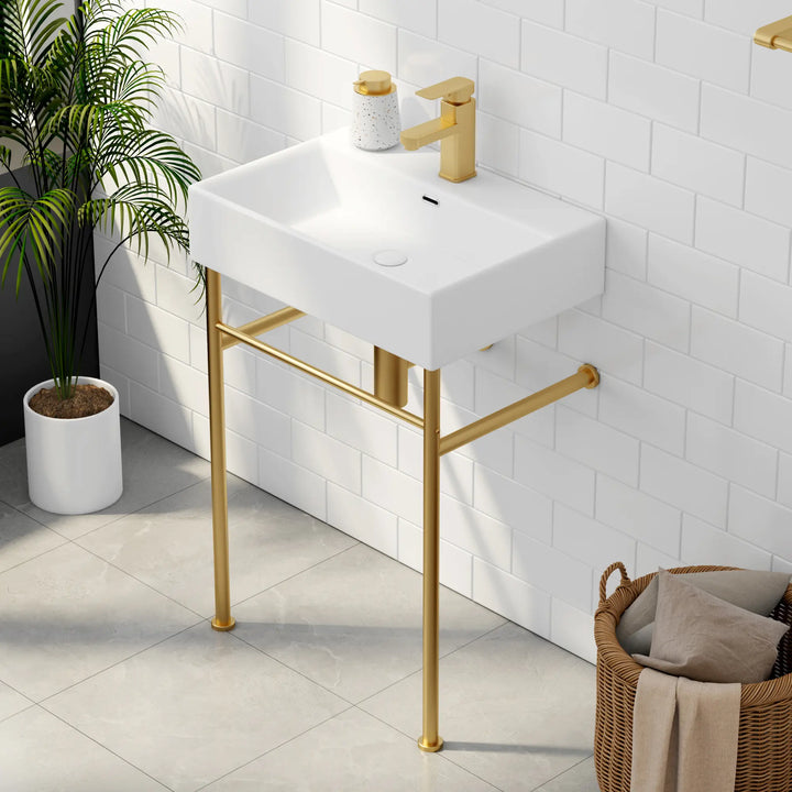 White rectangular sink with gold faucet and metal legs