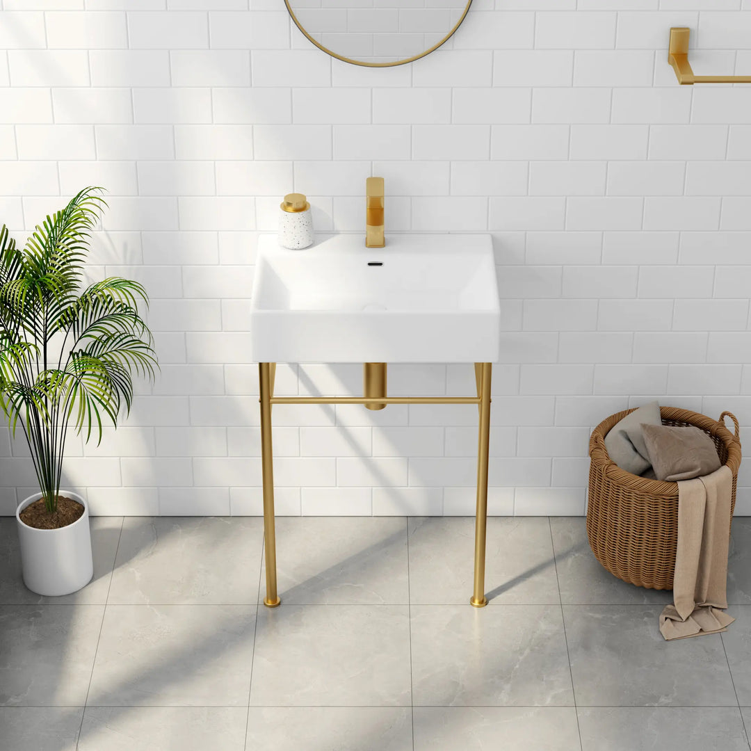 White rectangular sink with gold faucet and metal legs