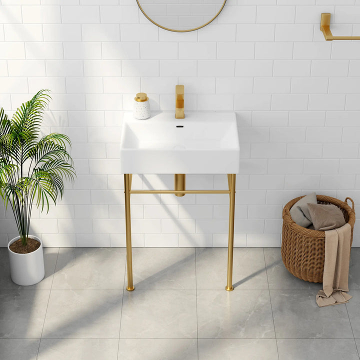 White rectangular sink with gold faucet and metal legs