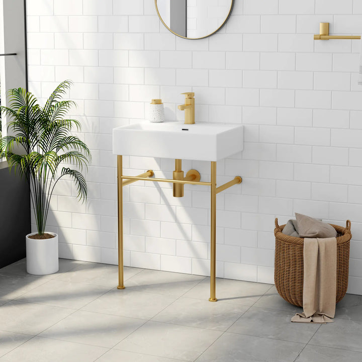 White rectangular sink with gold faucet and metal legs