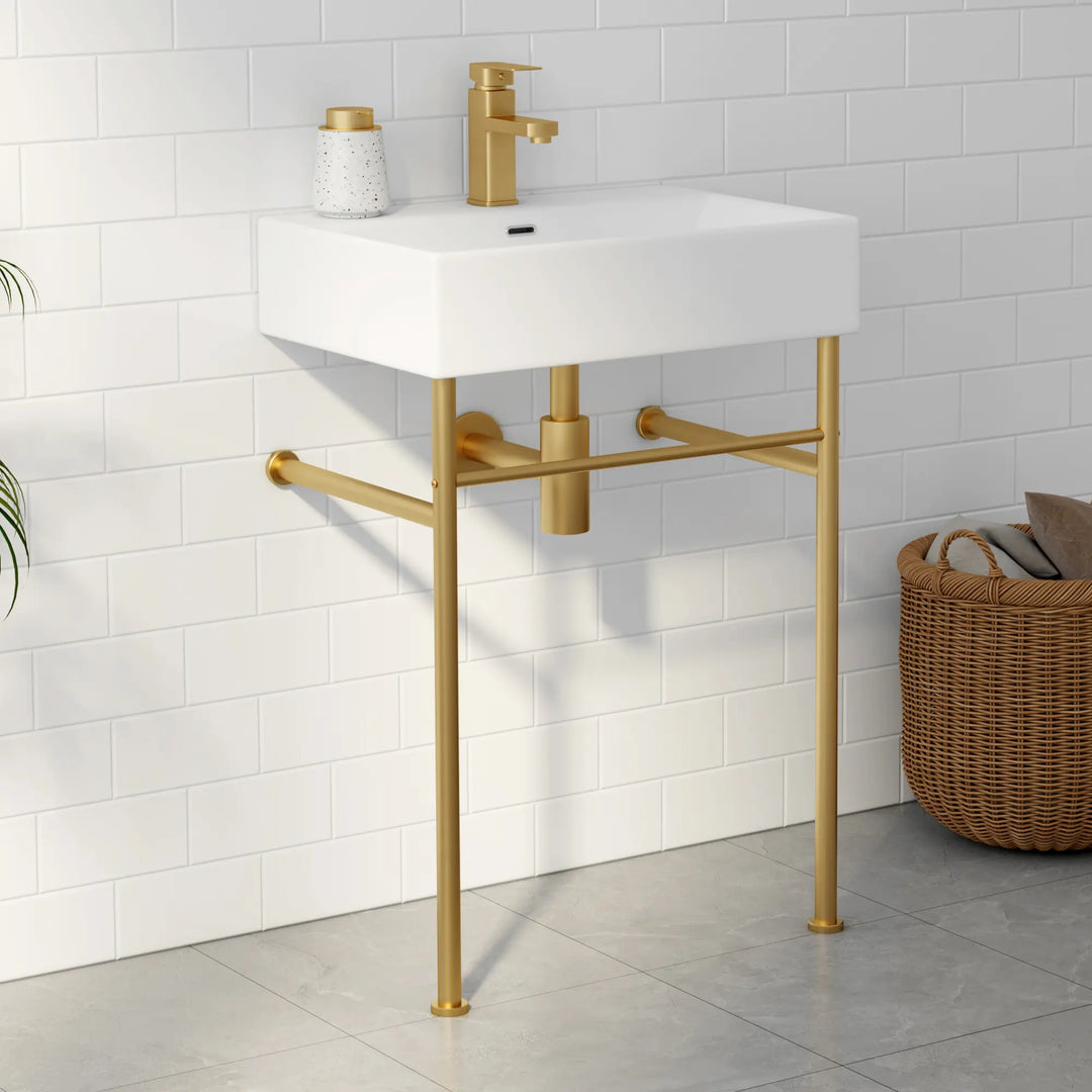 White wall-mounted rectangular sink with gold faucet and metal stand