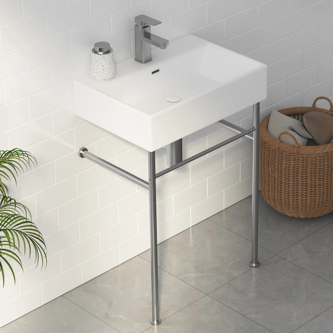 White rectangular ceramic bathroom sink with metal stand and faucet