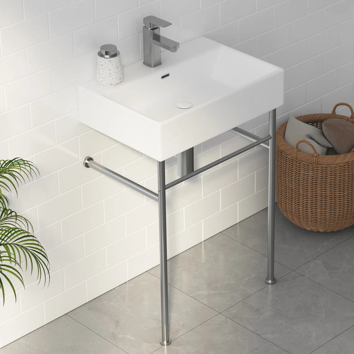 White rectangular ceramic bathroom sink with metal stand and faucet