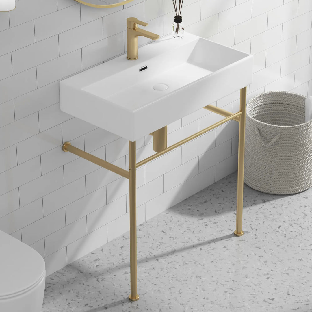 Eridanus white console sink with brass gold stand and faucet.