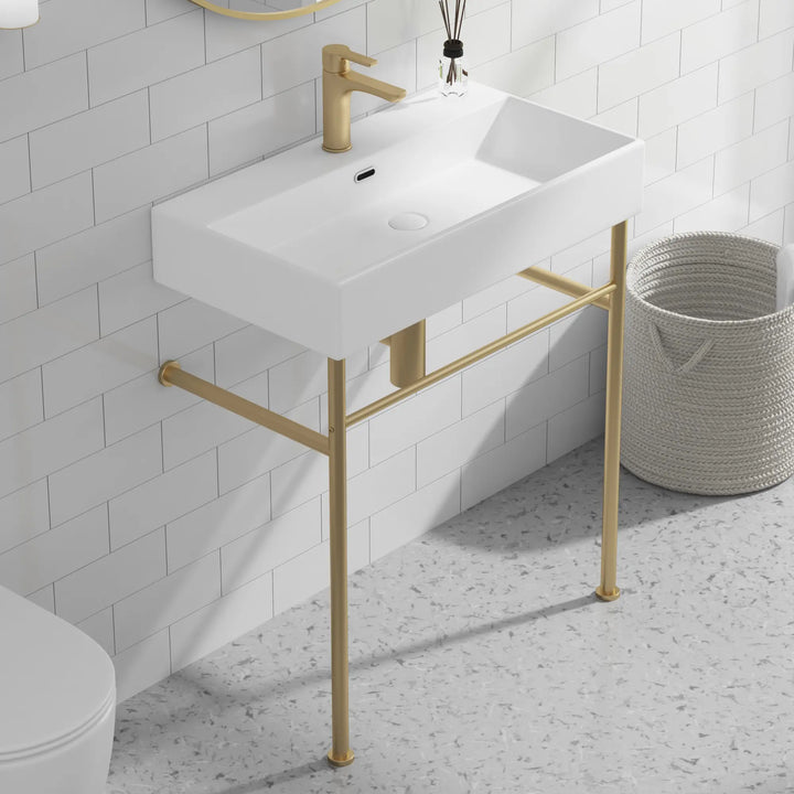 Eridanus white console sink with brass gold stand and faucet.