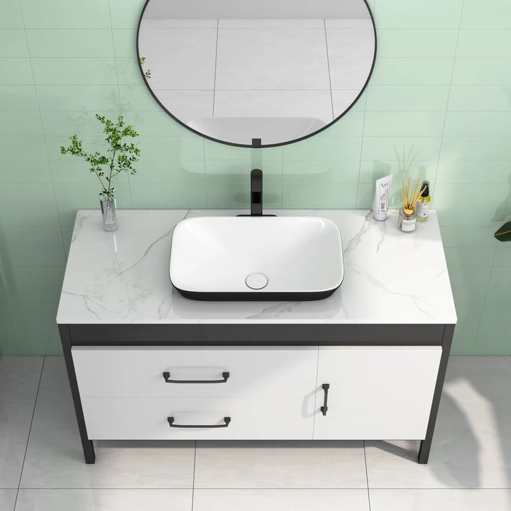 Two-tone rounded rectangular ceramic vessel sink with matte black faucet
