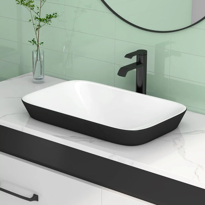 Black and white rectangular ceramic countertop vessel sink with matte black tall faucet