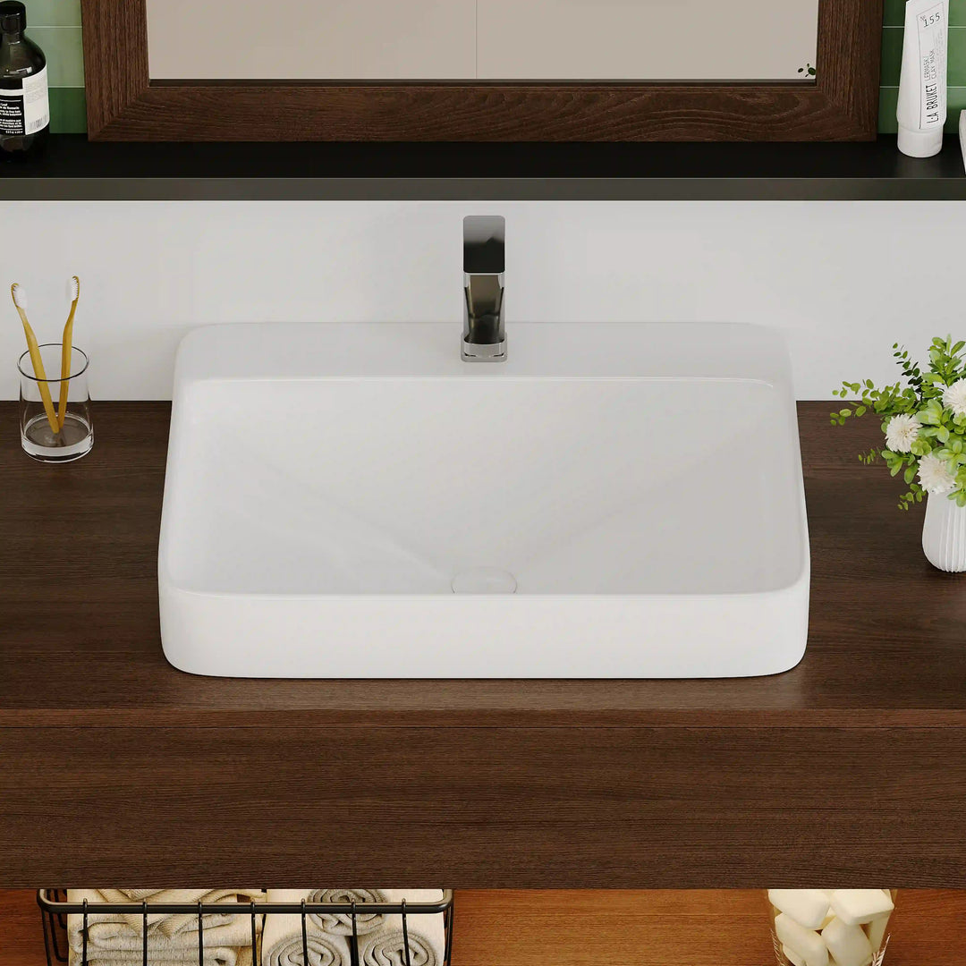White ceramic rectangular rounded vessel sink with chrome faucet