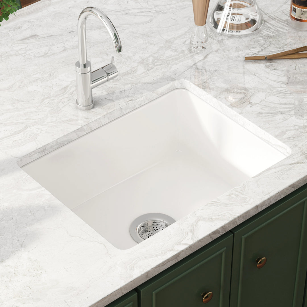 White undermount single bowl kitchen sink with drain strainer.