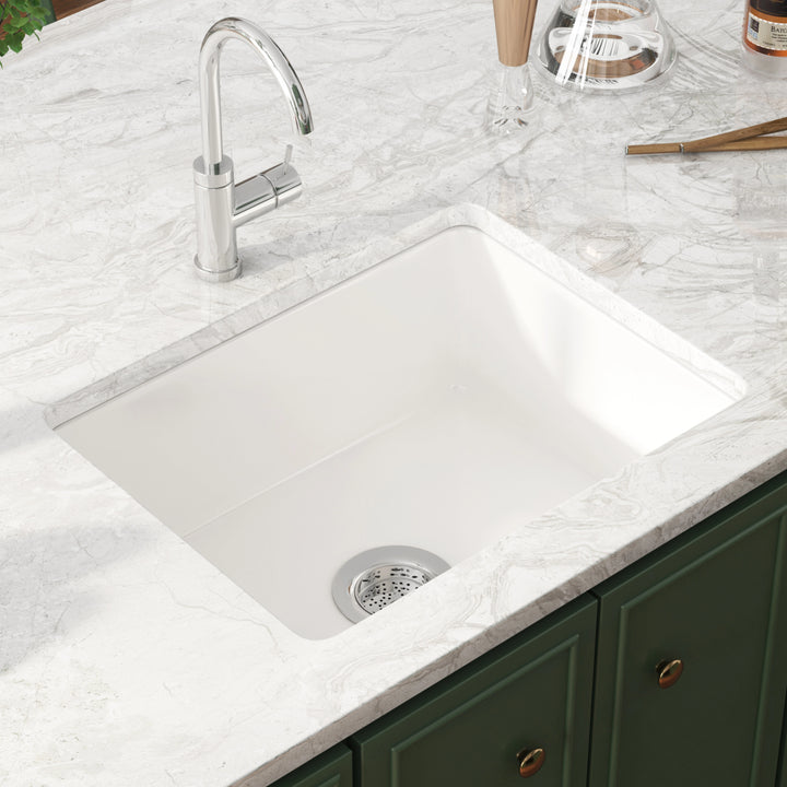 White undermount single bowl kitchen sink with drain strainer.