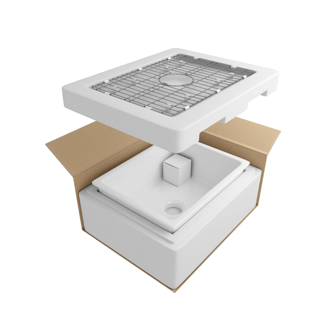Farmhouse kitchen sink with stainless steel bottom grid and protective packaging components.
