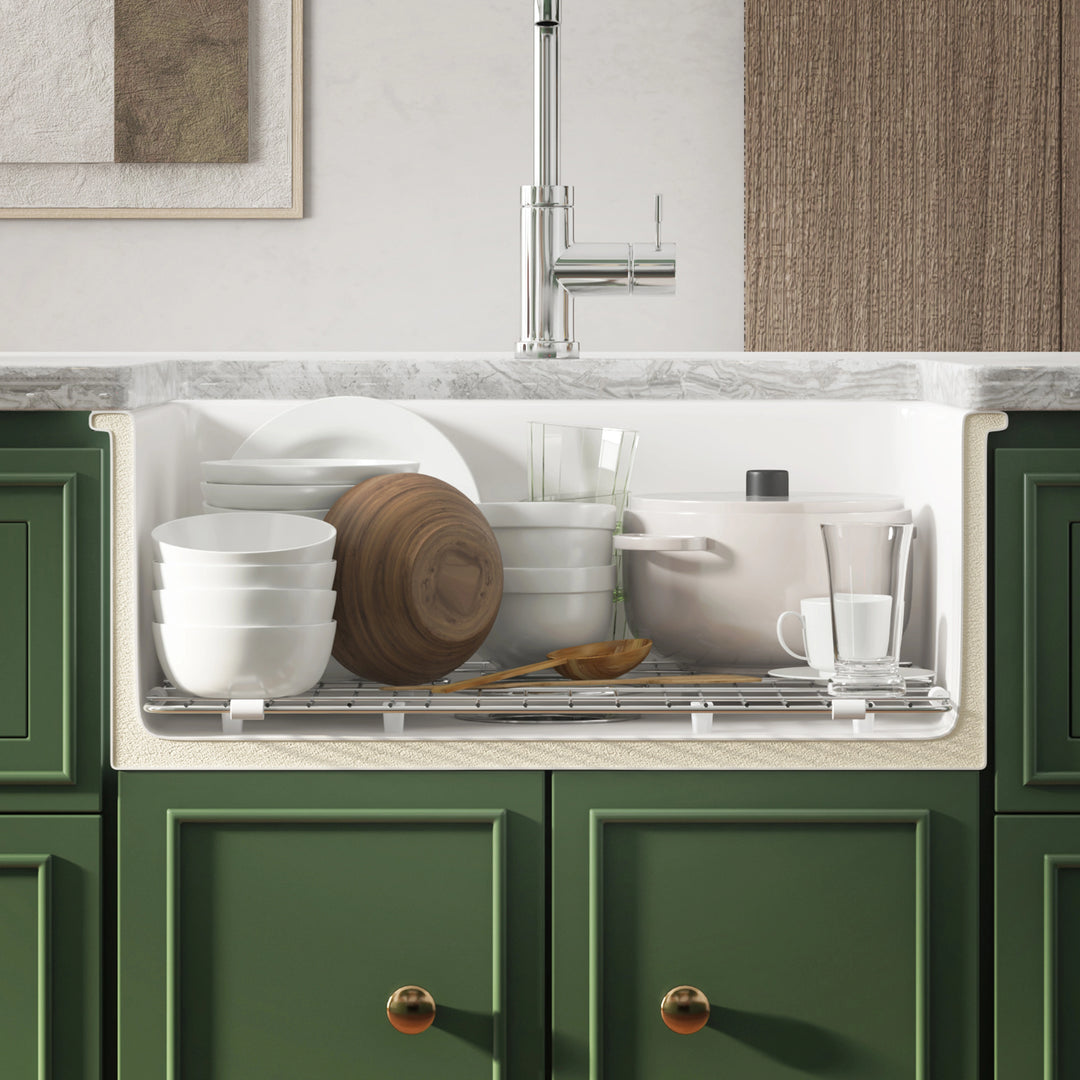 Deep single bowl kitchen sink filled with dishes and pots