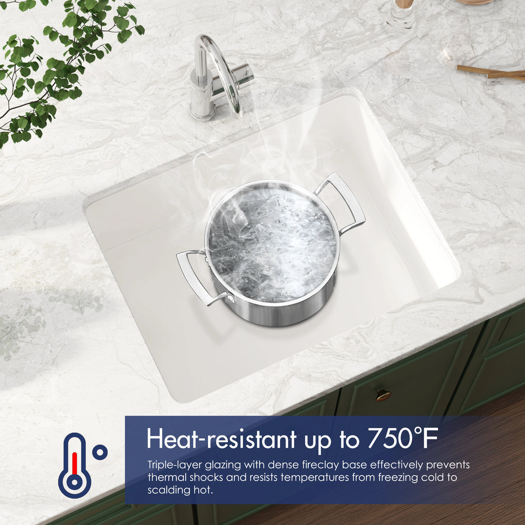 White fireclay undermount kitchen sink with a boiling hot pot inside, highlighting its 750°F heat resistance.