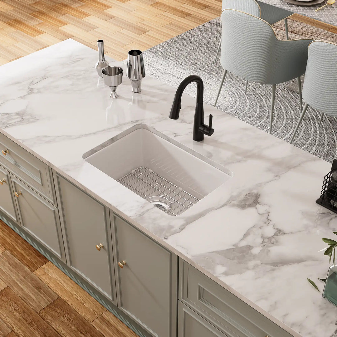 White undermount kitchen sink with black faucet and grid