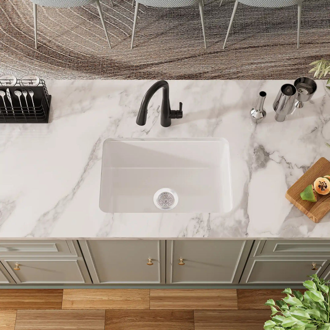 White undermount kitchen sink with black faucet and grid