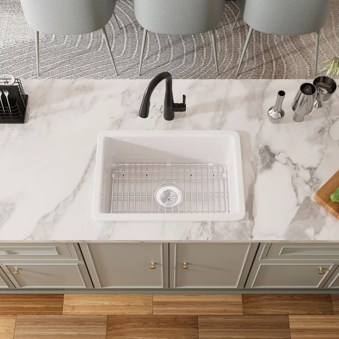 White undermount kitchen sink with black faucet and grid