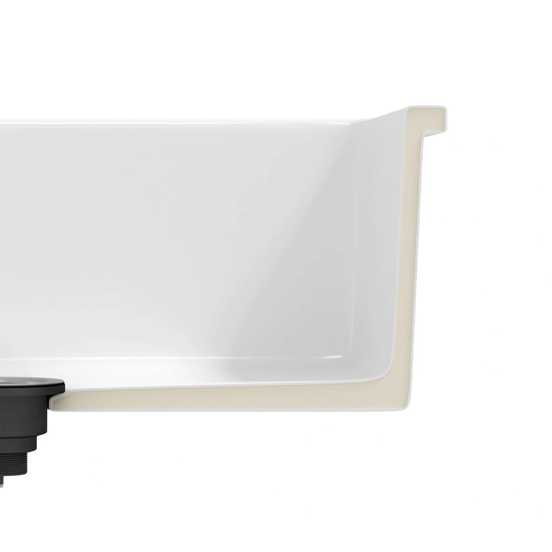 White fireclay kitchen sink corner cross-section close-up, thick sound dampening wall and drain fitting