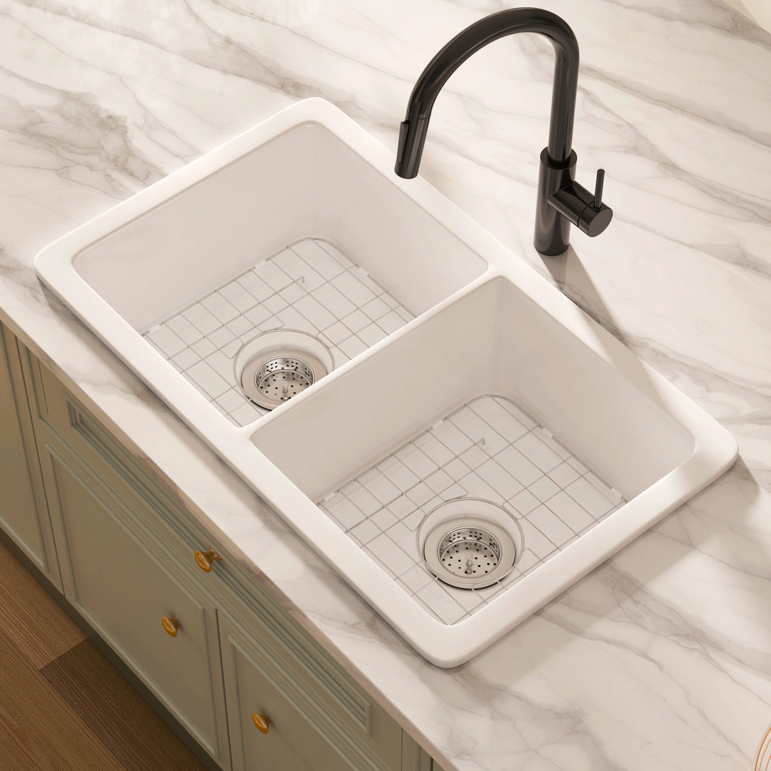 White topmount double-bowl kitchen sink with stainless steel bottom grids and strainers.