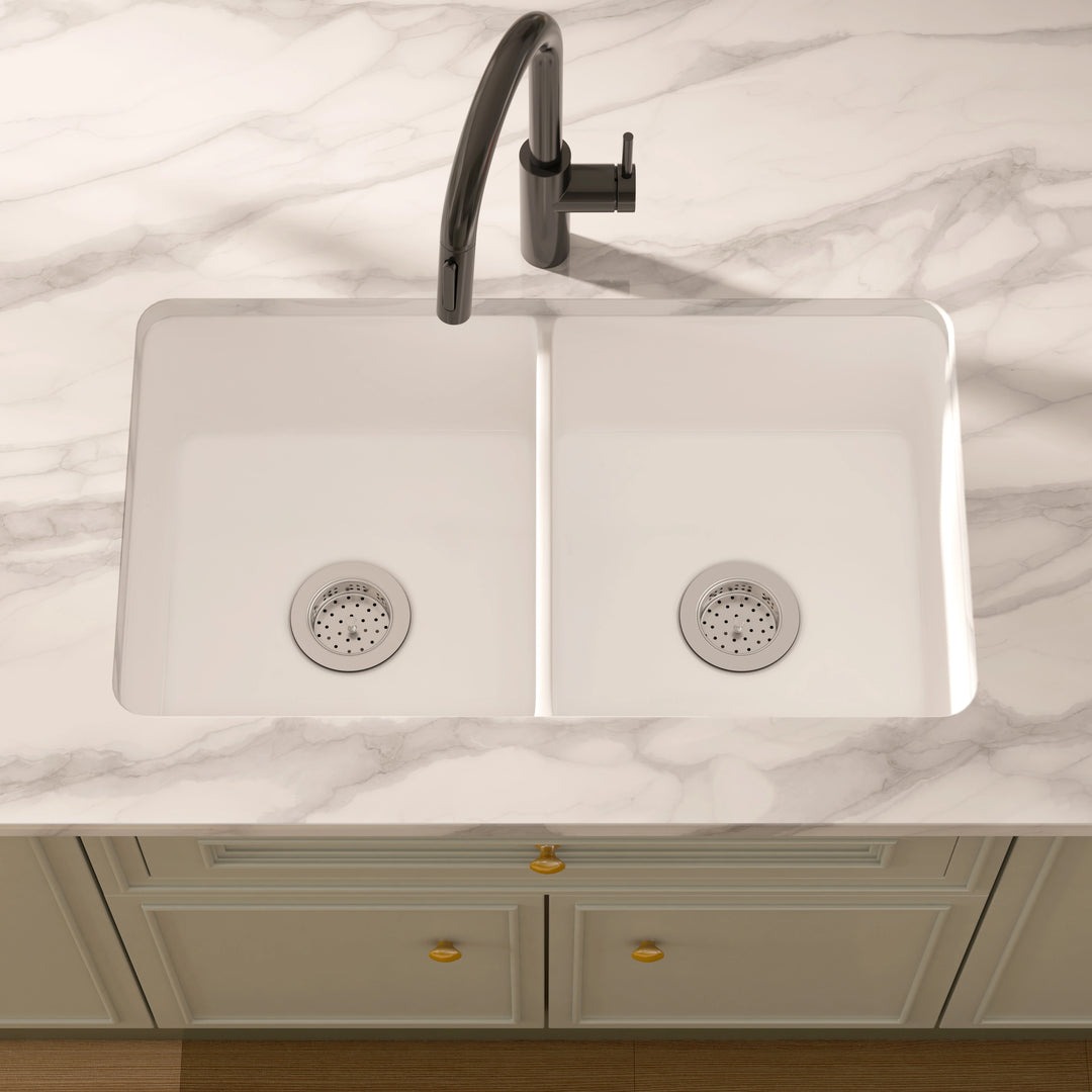 White composite double-bowl undermount kitchen sink with stainless steel strainers.
