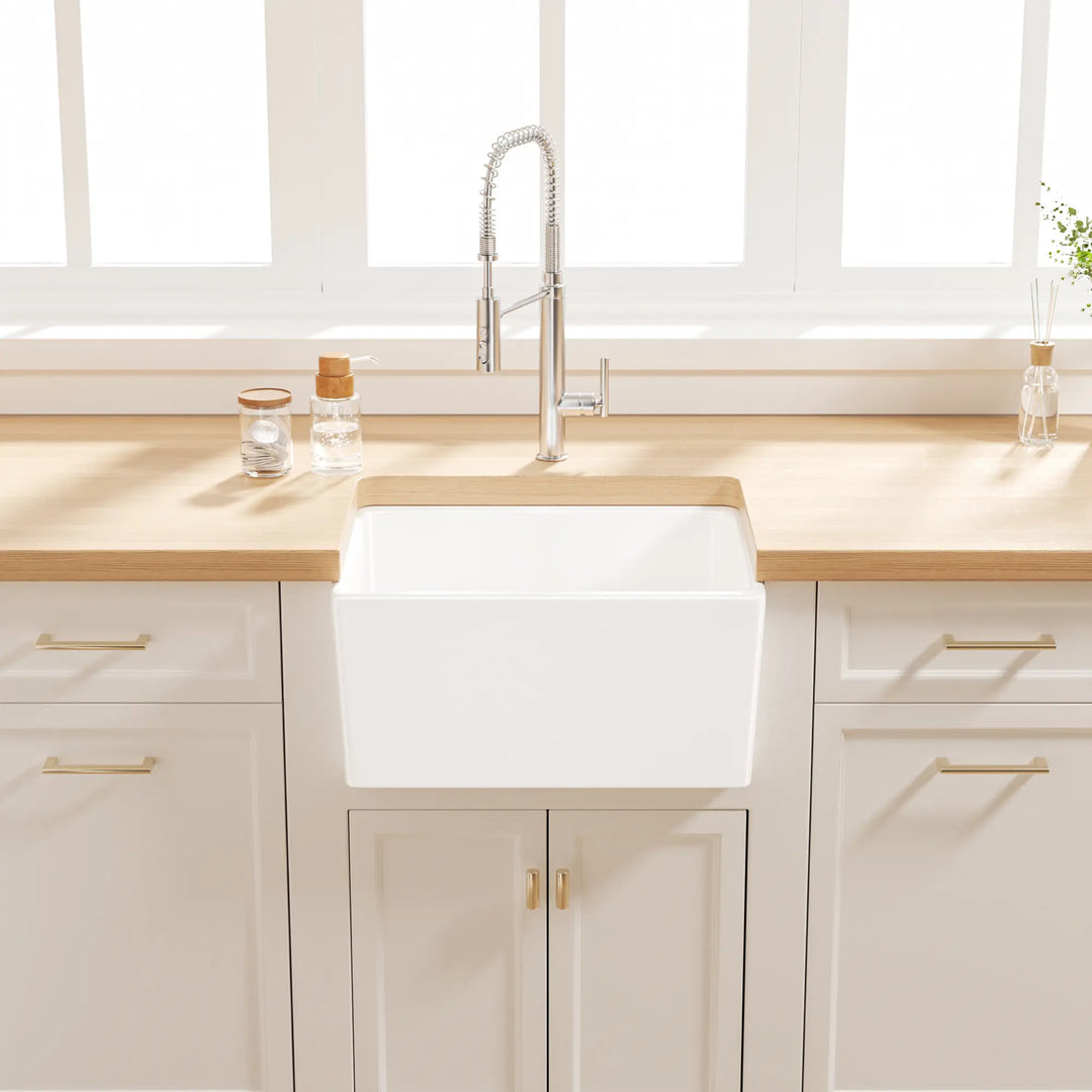 White farmhouse apron sink with grid rack in a modern kitchen
