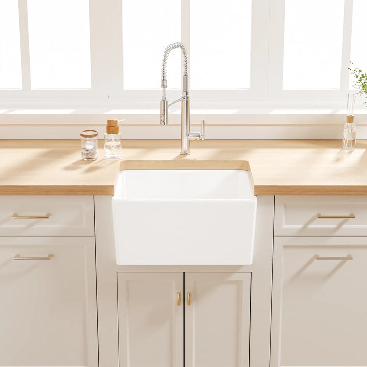 White farmhouse apron sink with grid rack in a modern kitchen