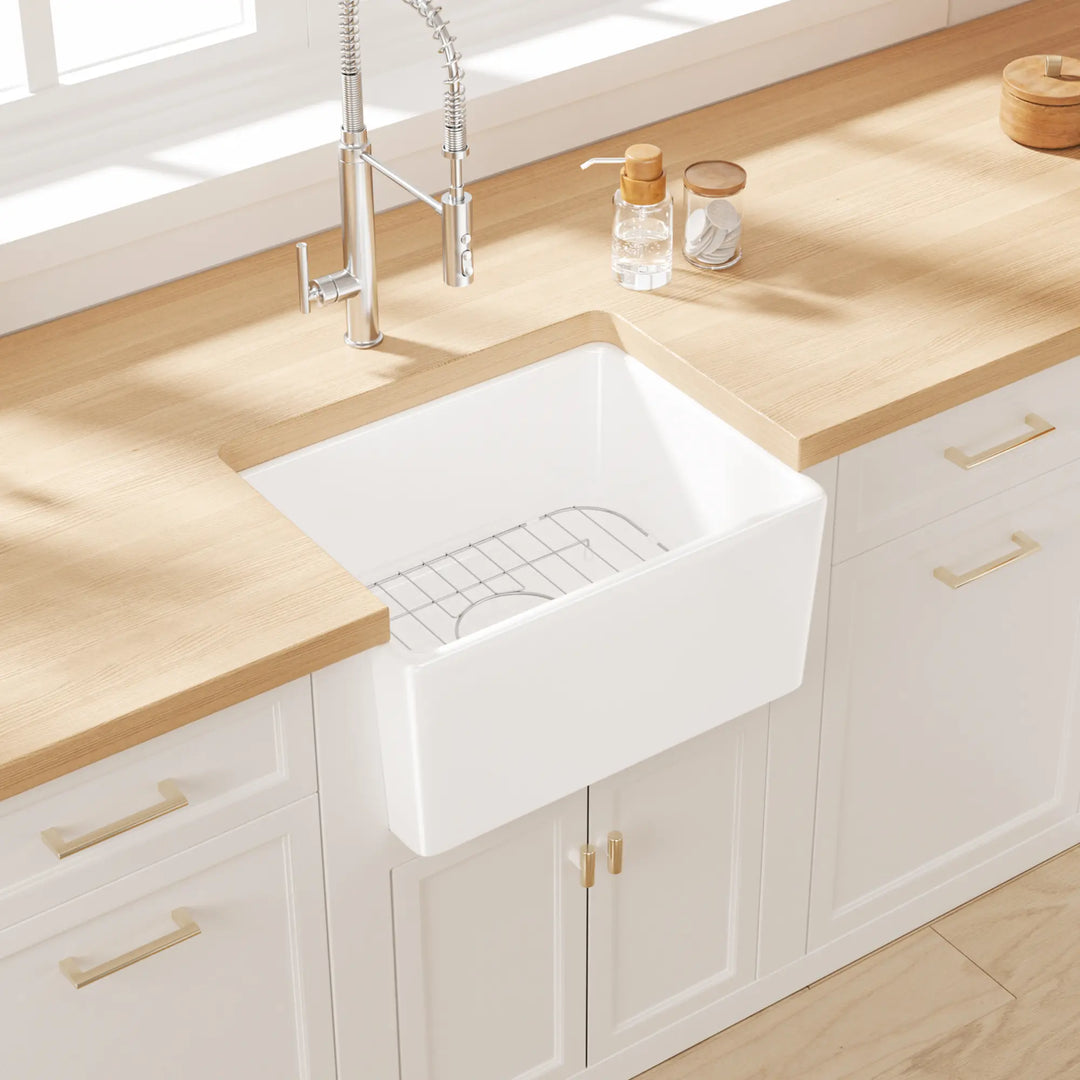 White farmhouse apron sink with grid rack in a modern kitchen