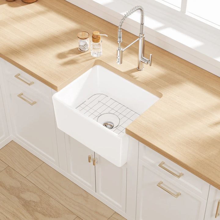 White farmhouse apron sink with grid rack in a modern kitchen