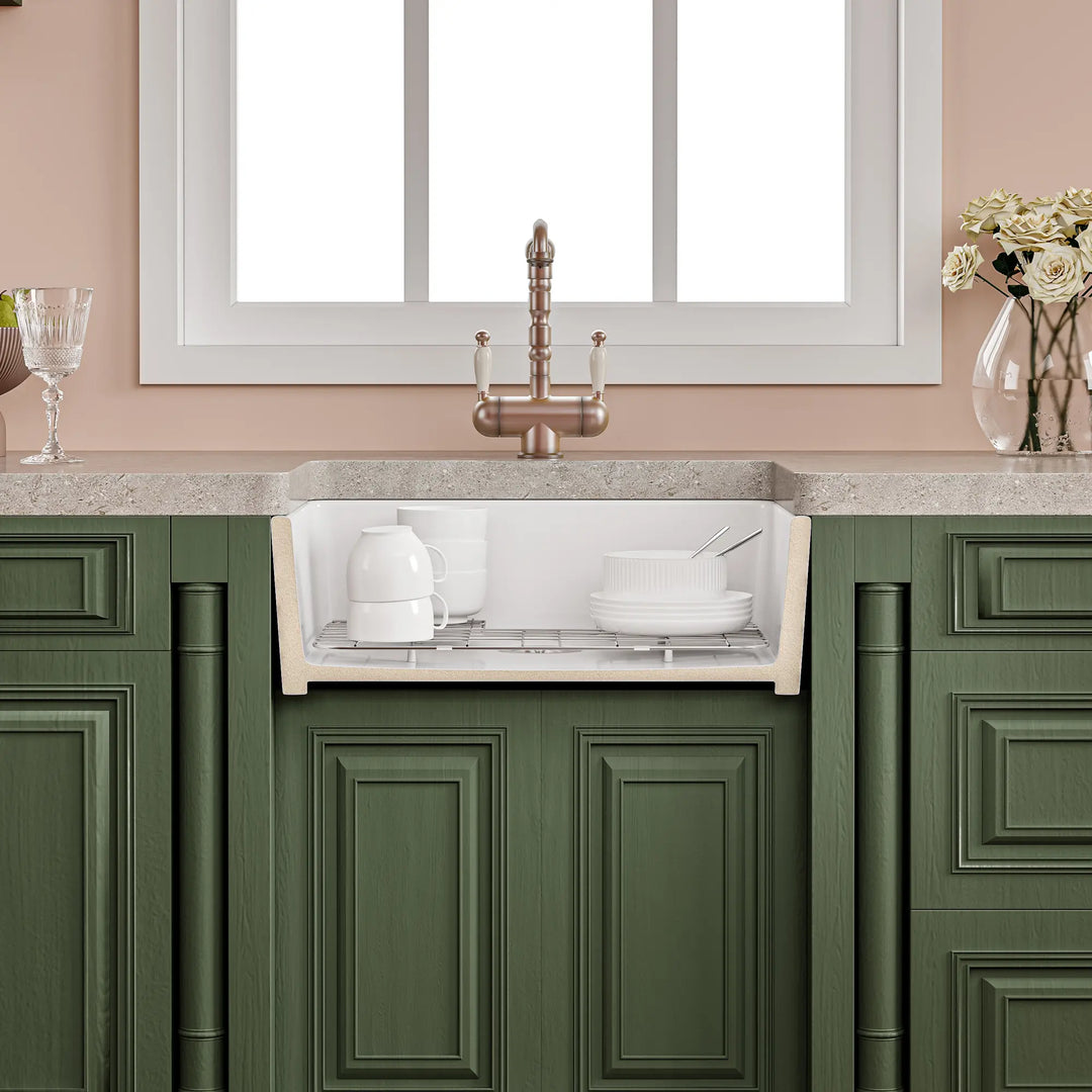 White fireclay farmhouse kitchen sink cross-section showing deep basin with dishes