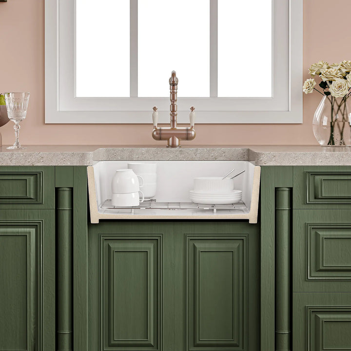 White fireclay farmhouse kitchen sink cross-section showing deep basin with dishes