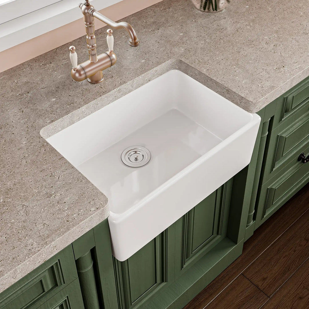 White fireclay farmhouse kitchen sink with apron front design