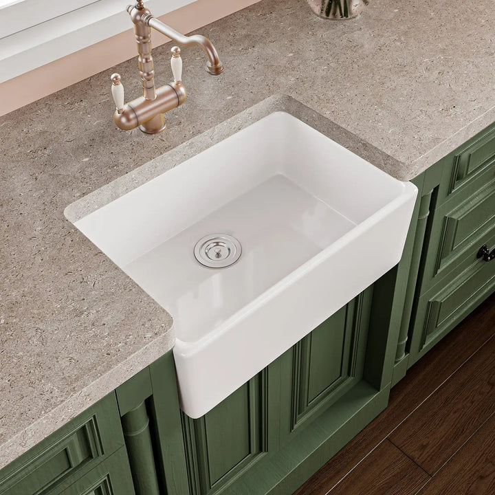 White fireclay farmhouse kitchen sink with apron front design