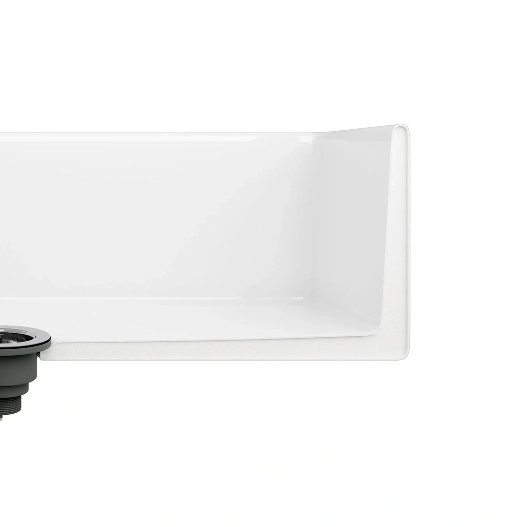 White fireclay sink corner detail with smooth rounded edge and sink drain assembly