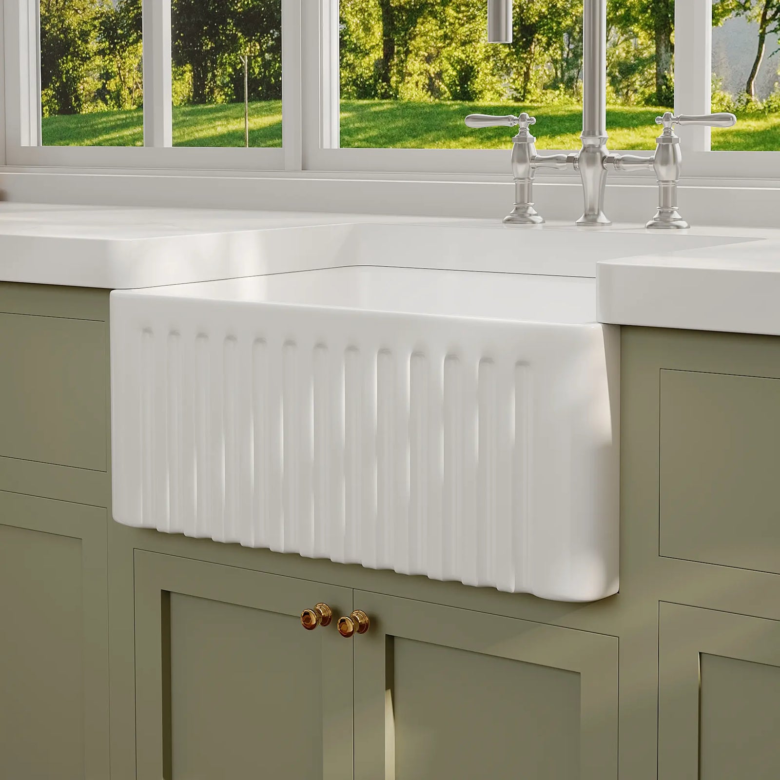 White ceramic farmhouse apron sink with fluted front