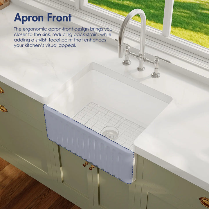 White ceramic farmhouse sink with fluted apron front and bottom grid