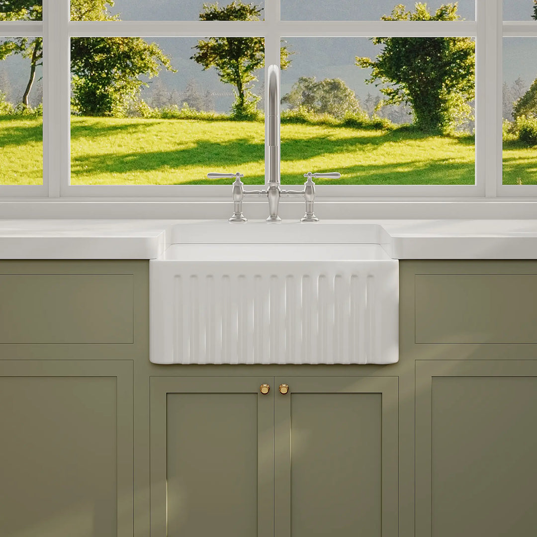 White ceramic farmhouse sink with fluted apron front design