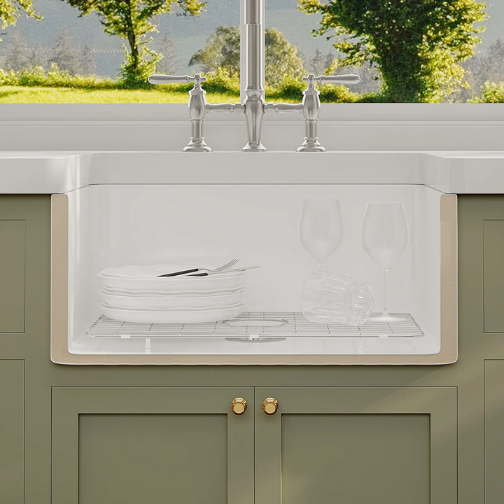 White ceramic farmhouse sink with deep basin and bottom grid