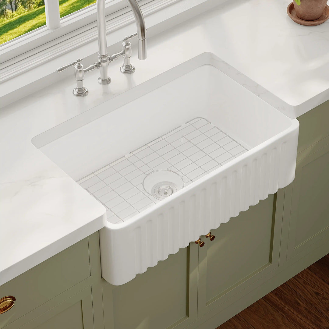 White fluted front fireclay farmhouse single bowl kitchen sink with classic apron design