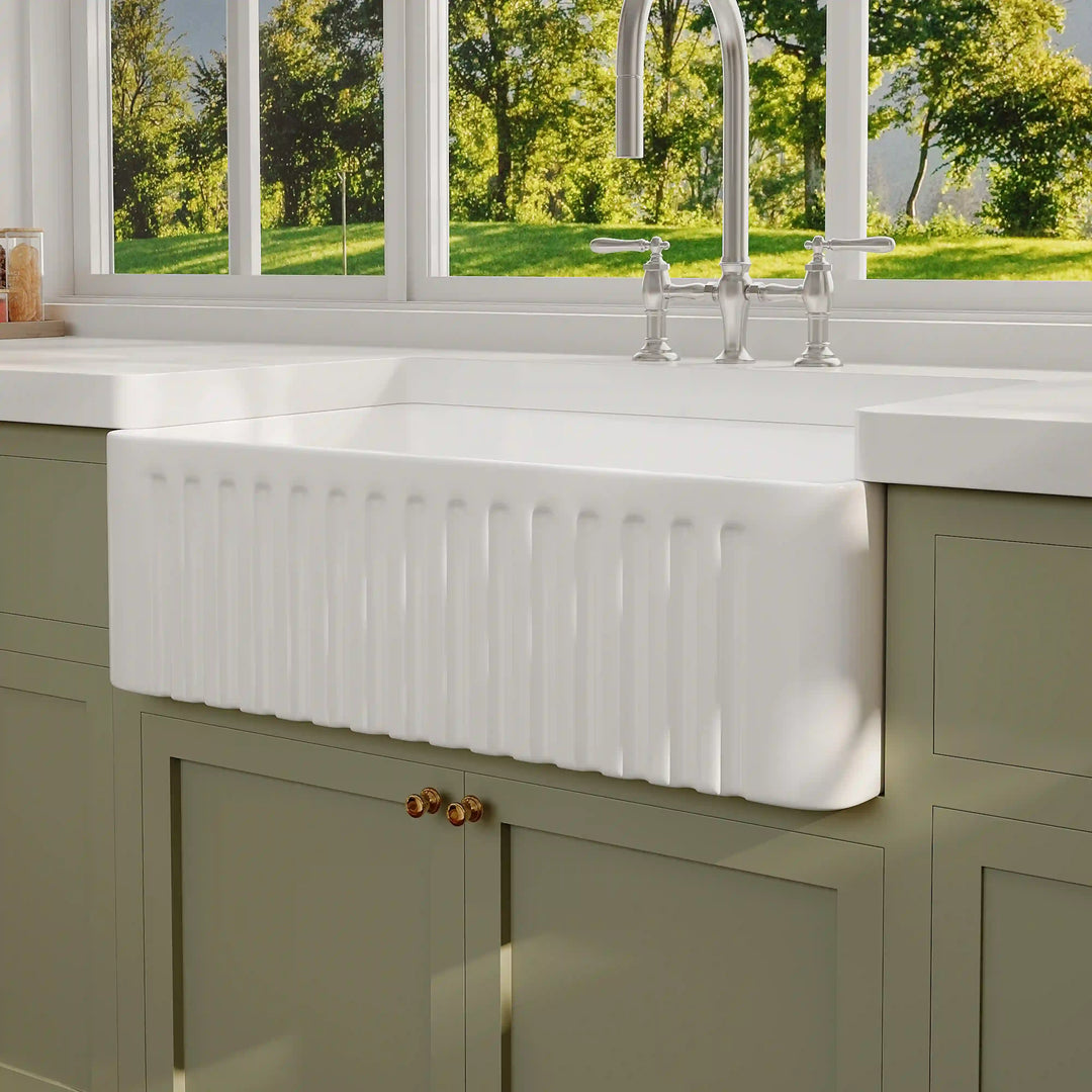 White fluted front fireclay farmhouse single bowl kitchen sink with classic apron design