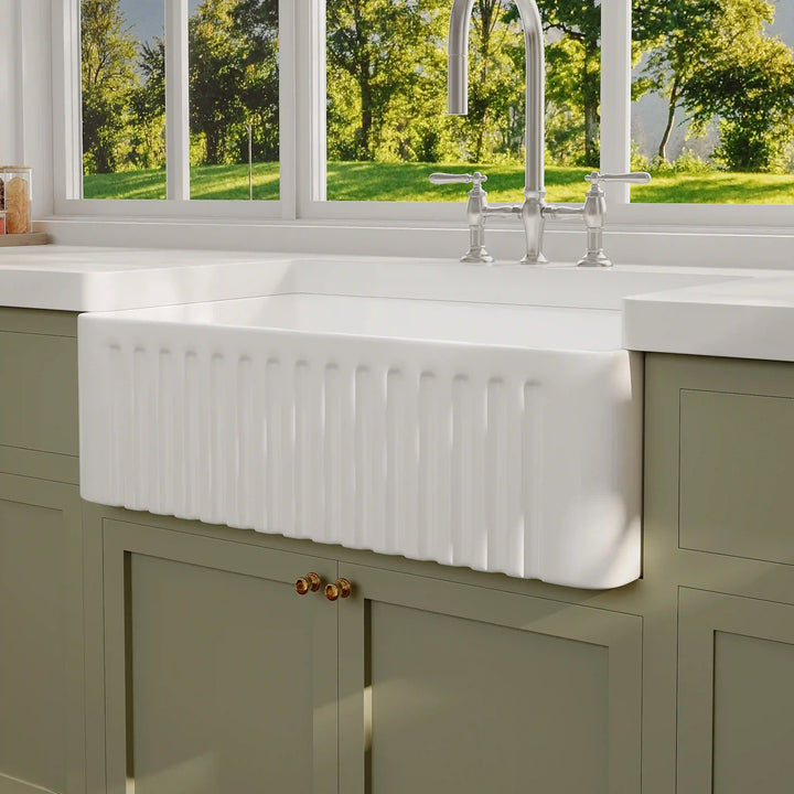 White fluted front fireclay farmhouse single bowl kitchen sink with classic apron design