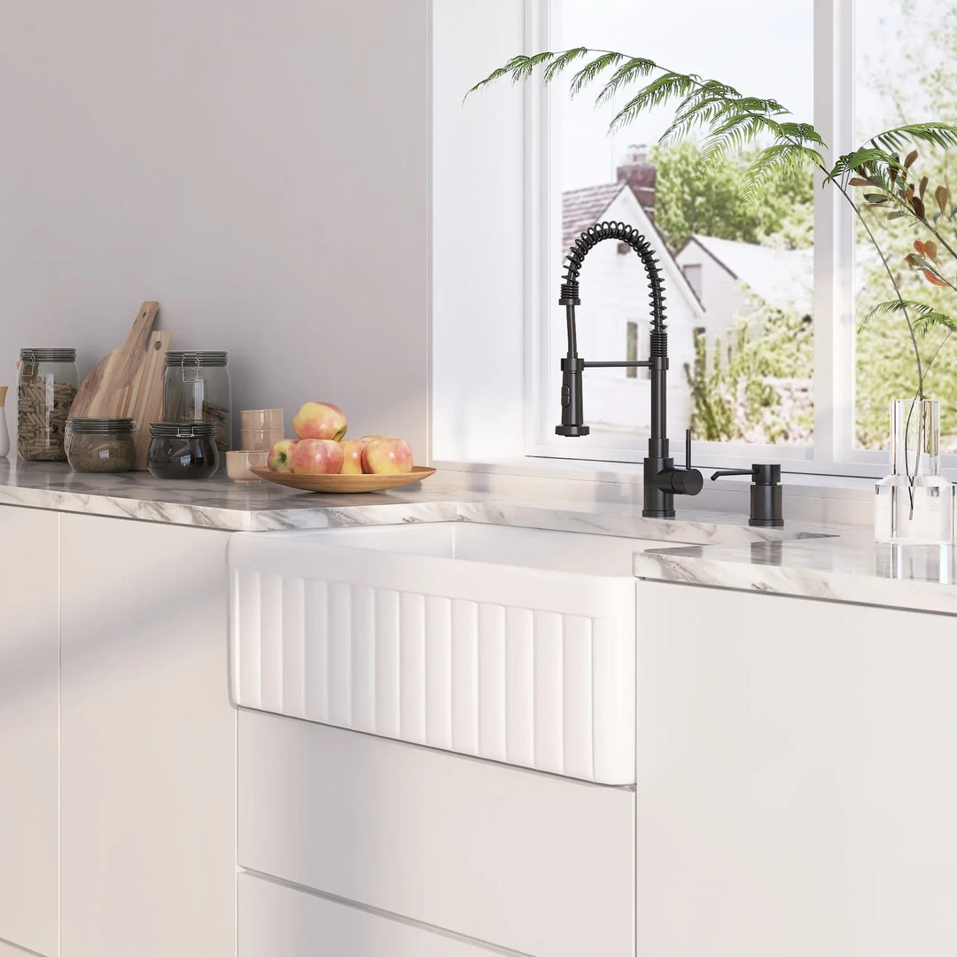 White fireclay farmhouse kitchen sink with vertical fluted front apron