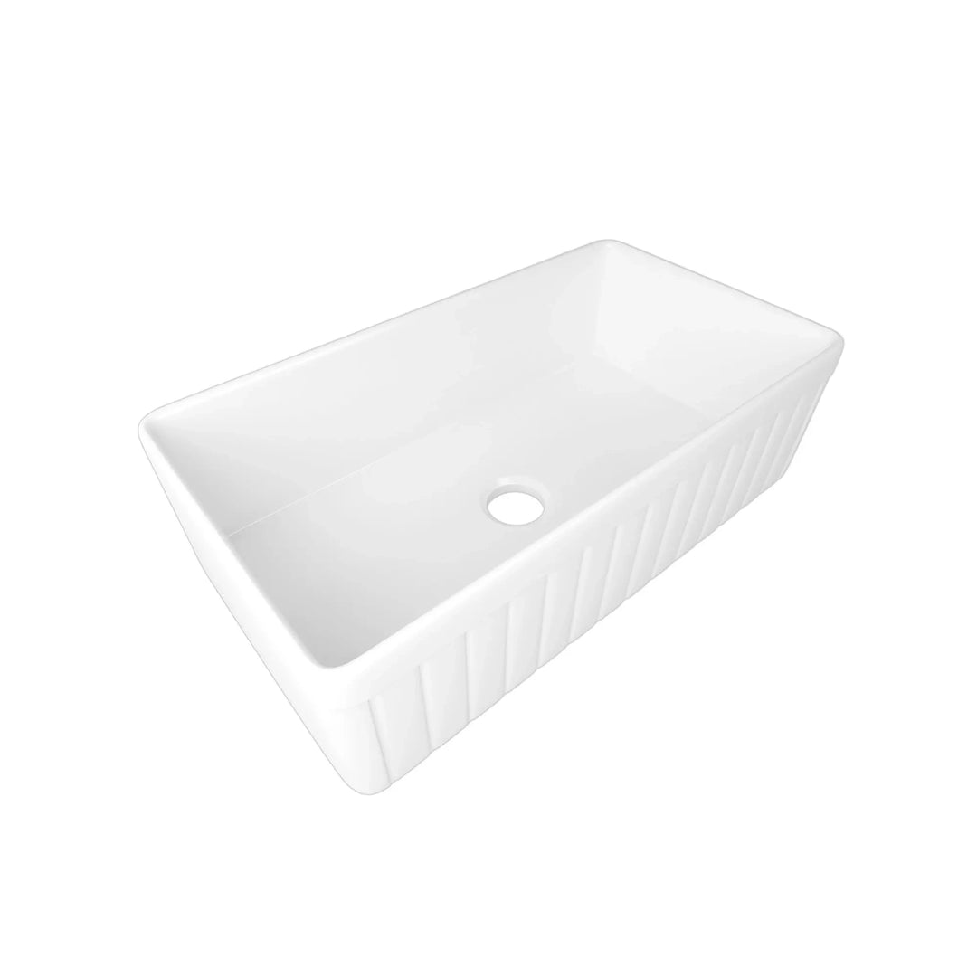 Glossy white fireclay farmhouse kitchen sink with fluted apron front