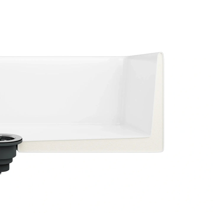 White fireclay sink corner cross-section showing thick solid wall and drain fitting