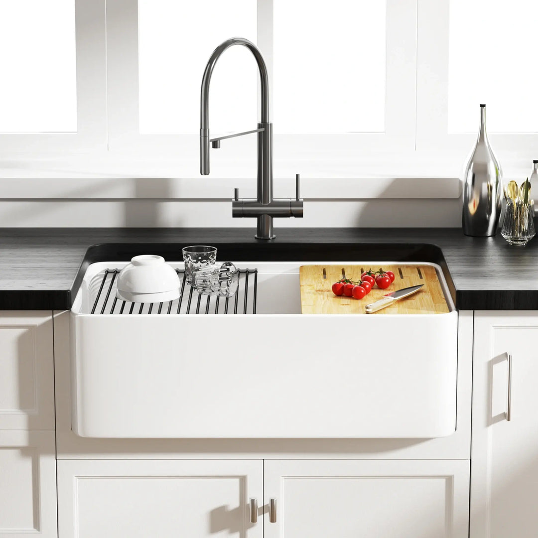 White fireclay double bowl farmhouse sink equipped with drying rack and bamboo cutting board