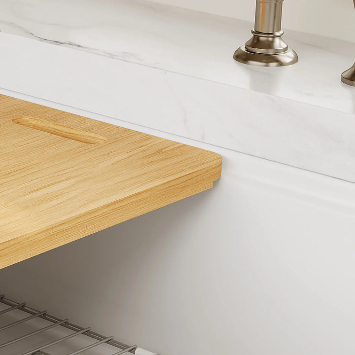 Wood cutting board detail on white workstation sink