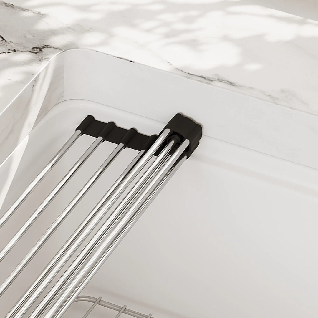 Stainless steel roll-up rack detail on white sink
