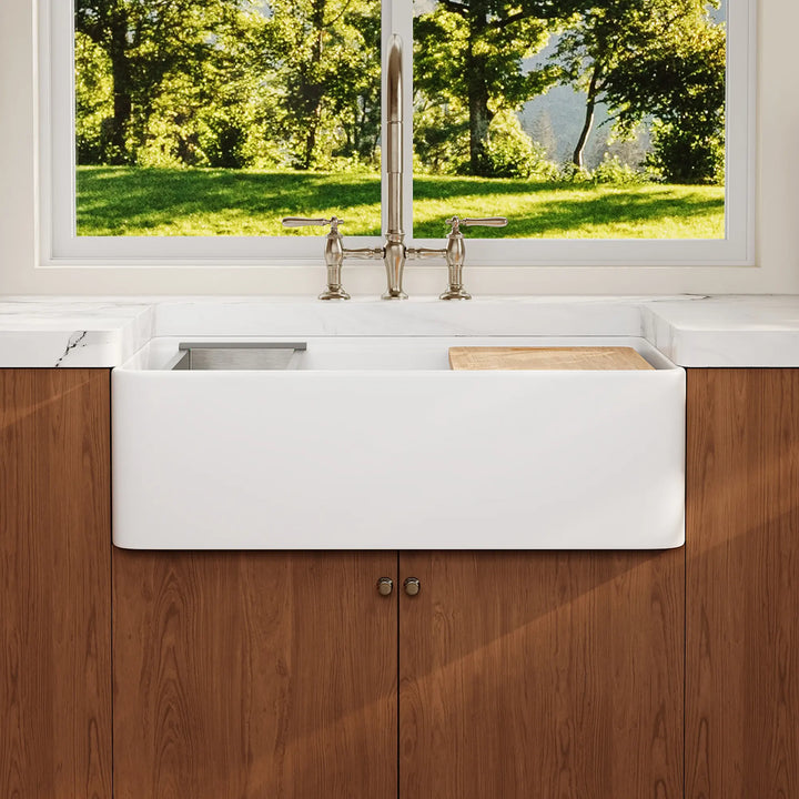 White farmhouse workstation sink with wood cutting board