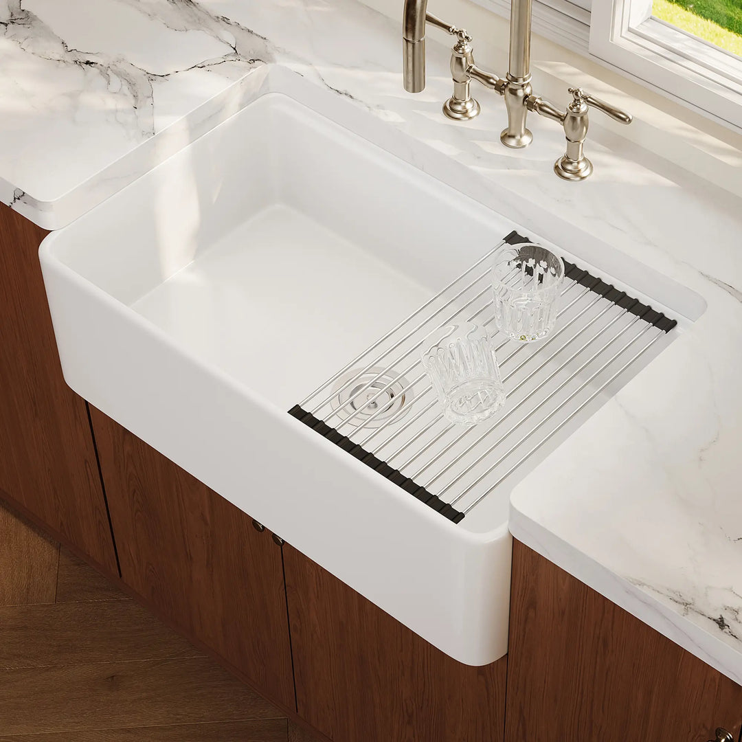 White farmhouse sink with roll-up dish drying rack