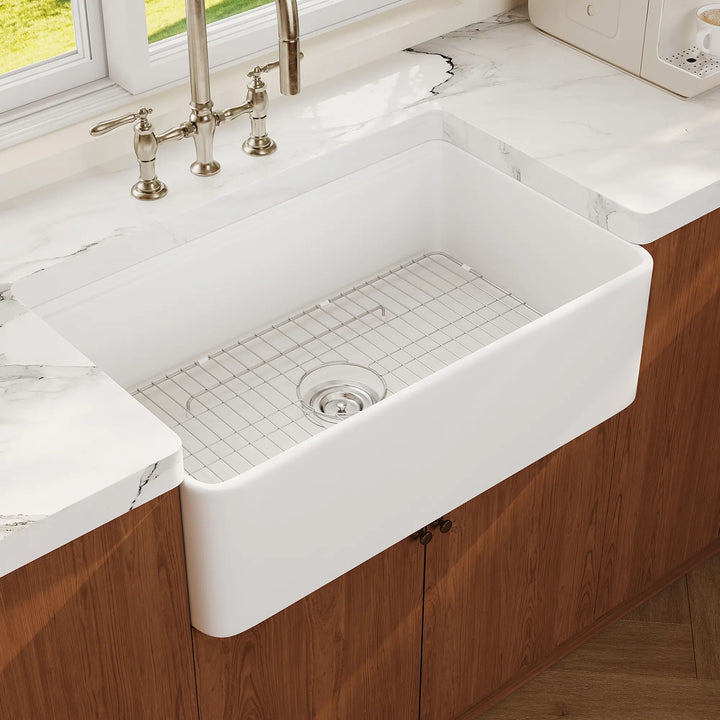 White farmhouse apron sink with protective bottom grid