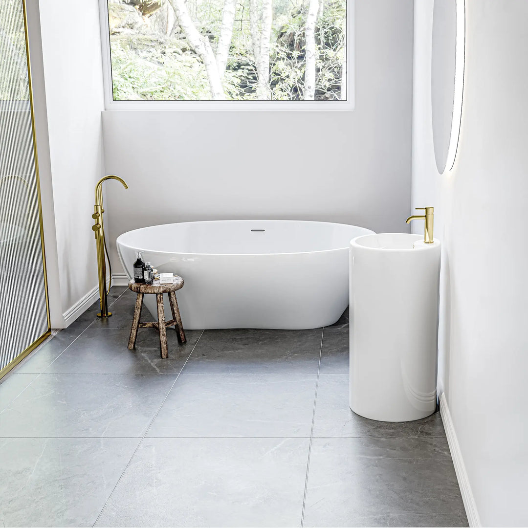 White freestanding pedestal sink with gold faucet, compact design